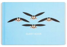 cover for a guest book with flying puffins