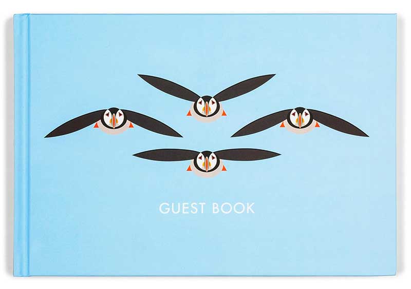 cover for a guest book with flying puffins